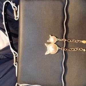 Over shoulder black bag white cat pearls on the front with Jewel handle